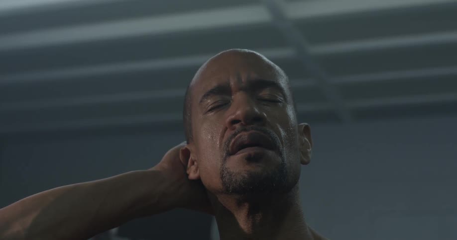 A man rubs the top and back of his head