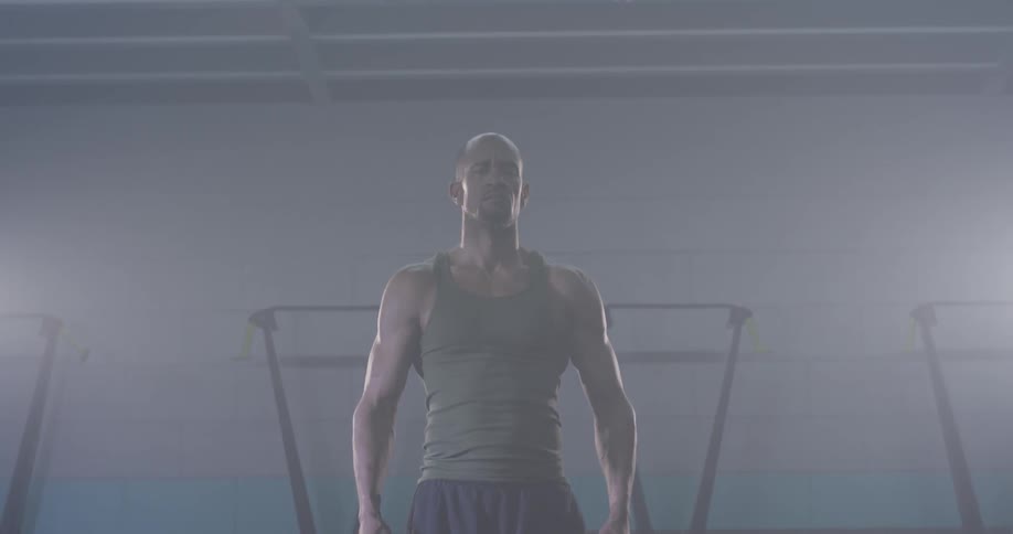 A man swinging his arms in a gym