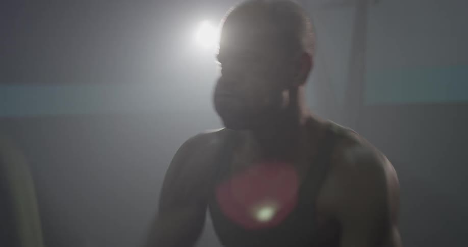 A man whips large ropes onto the floor