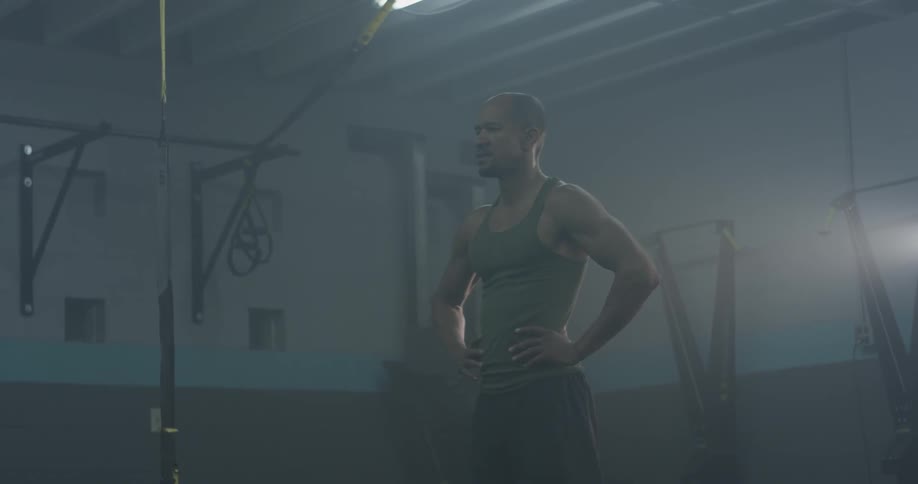 A man with his hands on his hips staring at an object