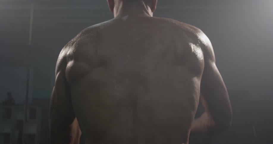 A man exercising with two ropes in a gym