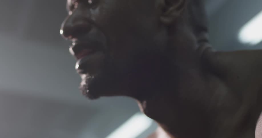 A man that is sweating in a gym