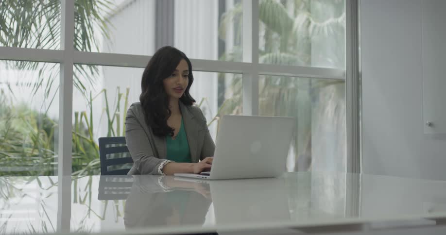 Woman typing on her laptop in an office