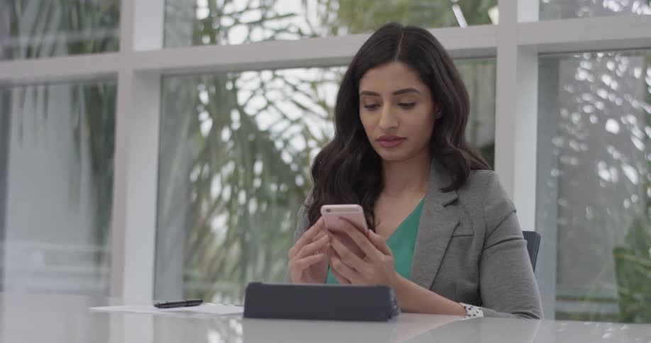 A woman typing on her cell phone