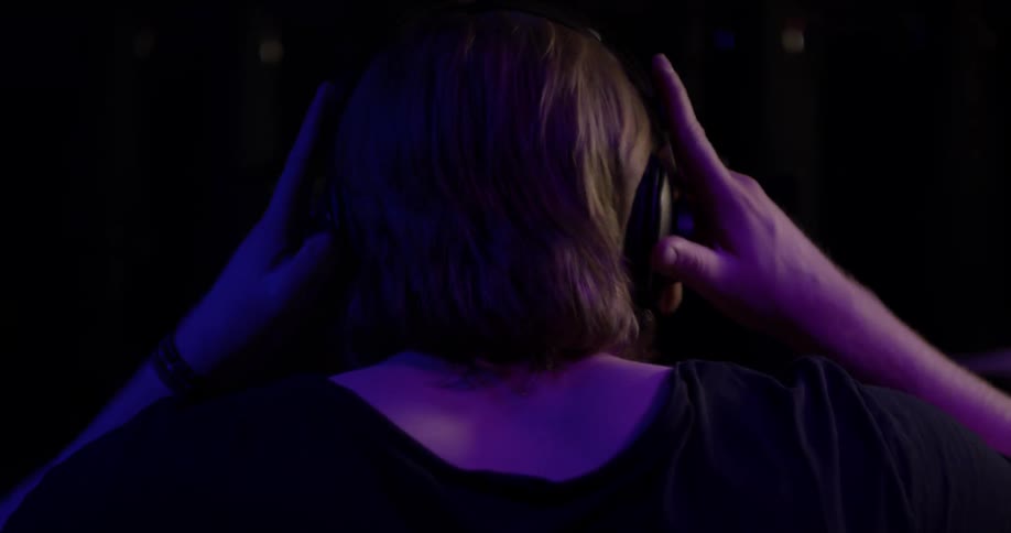 The backside of a man when he puts on headphones