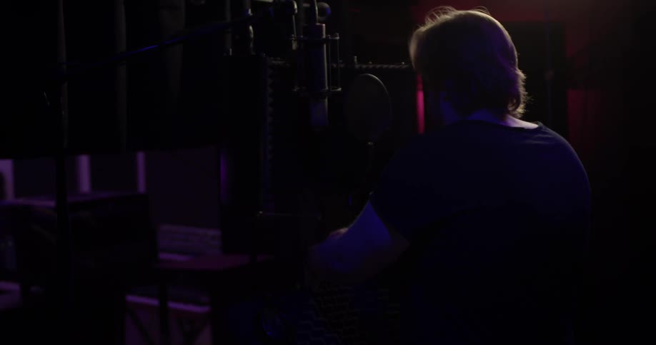 A man taking headphones off in a studio