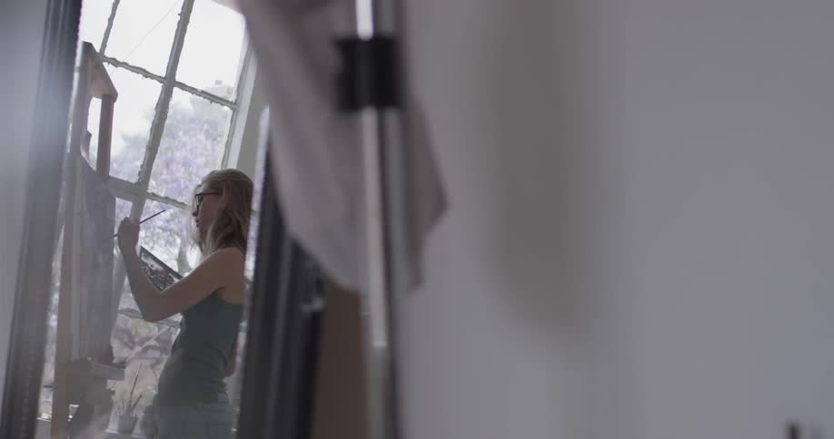 A woman painting in an art studio