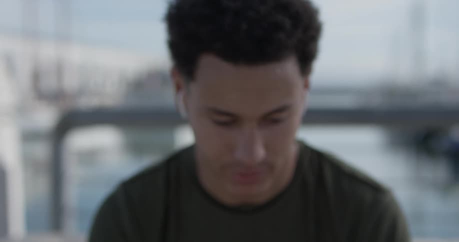 A man sitting down listening to music