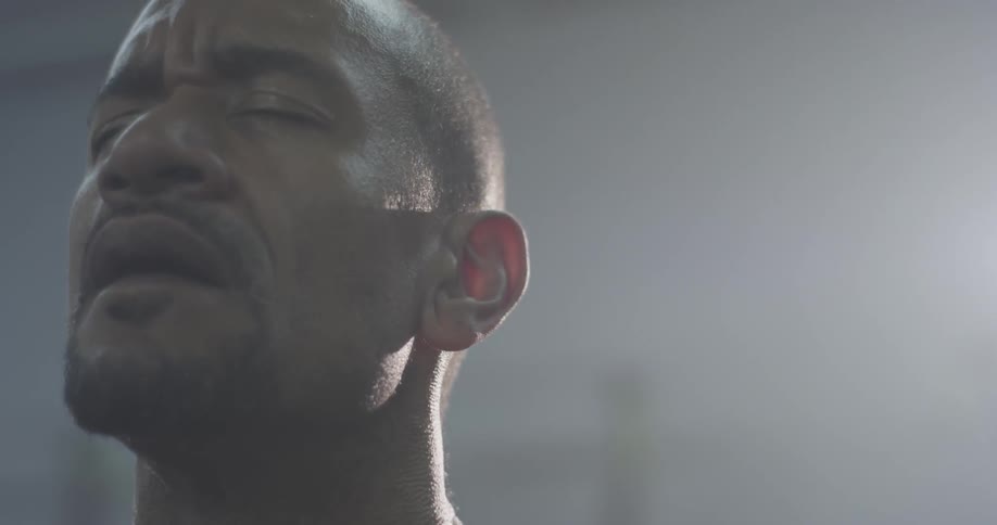 A man in a gym taking deep breaths