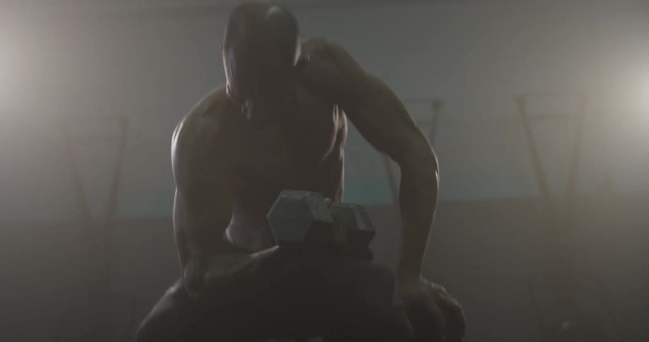 A man curling a barbell at a gym