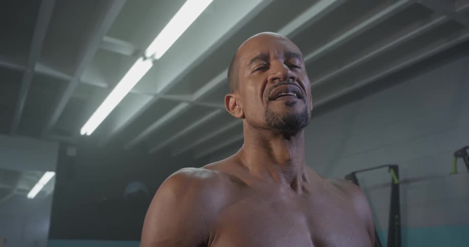 A man flexing and working out in a gym