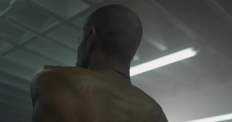 Man stretching and flexing in the gym
