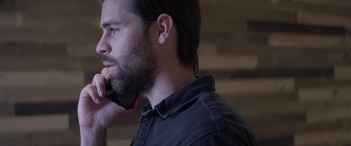 A man talking on a cell phone in a room