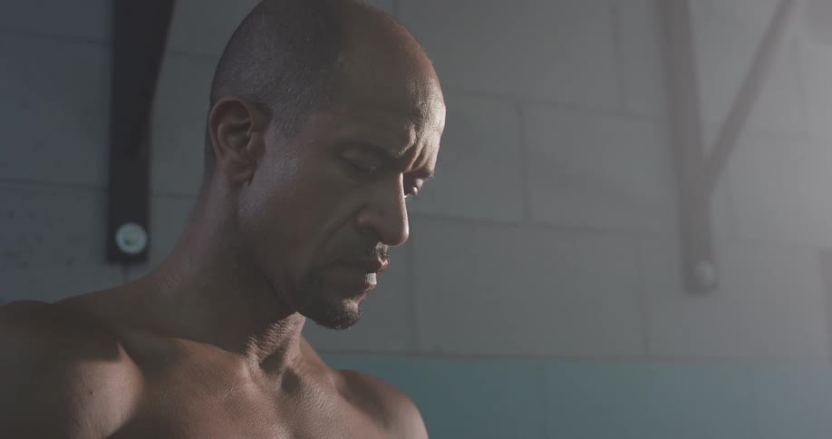 A man is looking down at his cell phone his hands