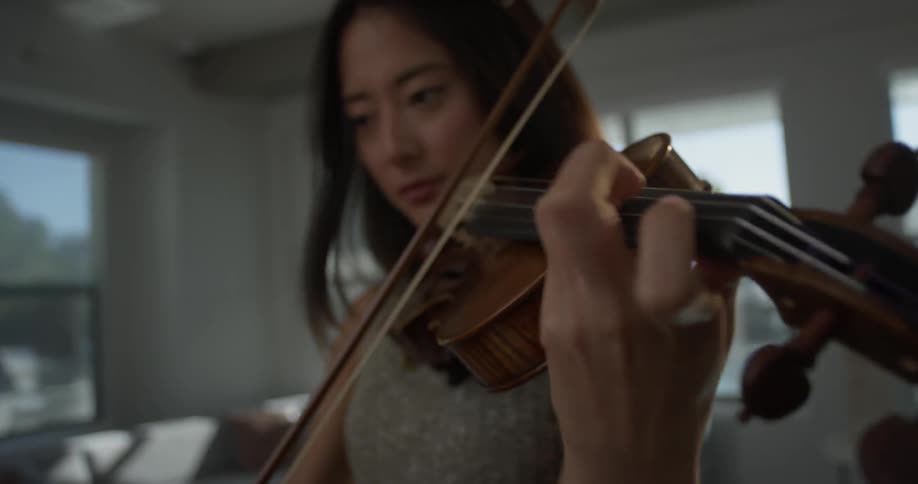 A woman is playing an instrument inside