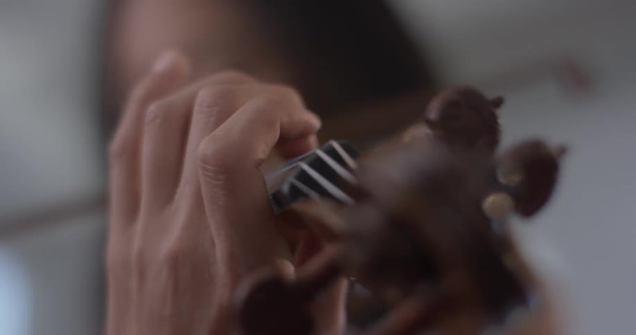 A woman playing a violin indoors