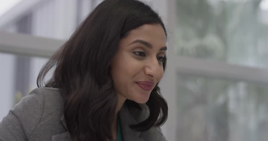 A woman is smiling, laughing and talking