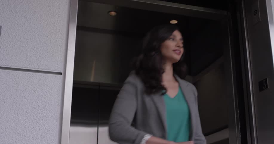 A woman walking out of an elevator