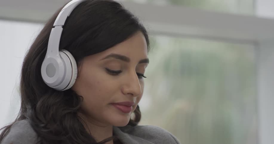 Woman listening to music on headphones