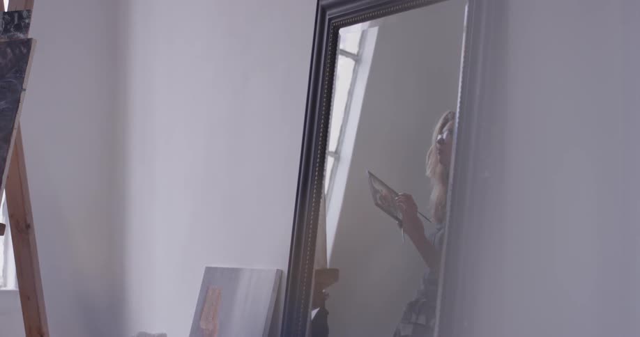 A woman is painting indoors
