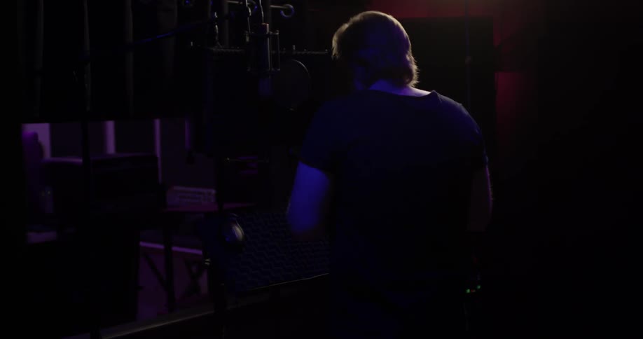 A man putting on headphones in a studio