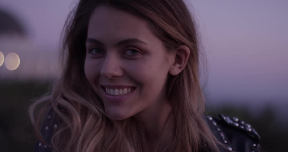 A woman is smiling outside