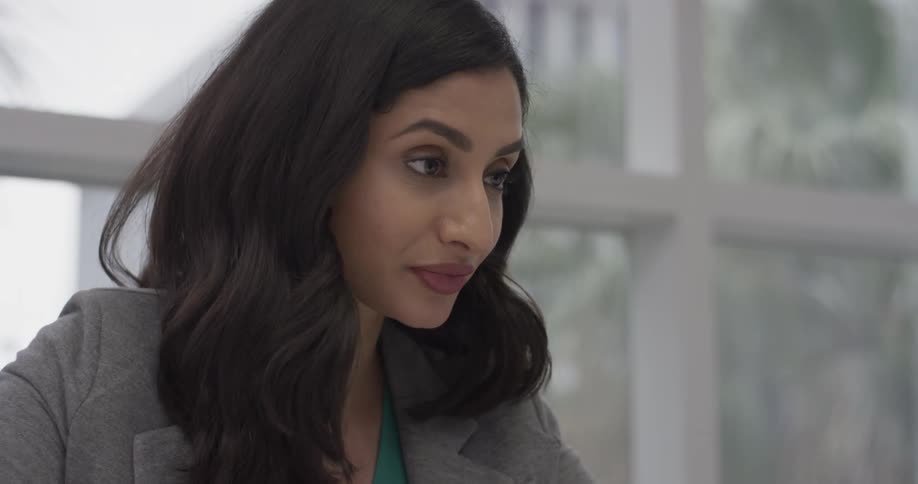 A woman talking to someone in an office
