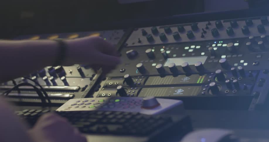 A person adjusting audio on a mixer
