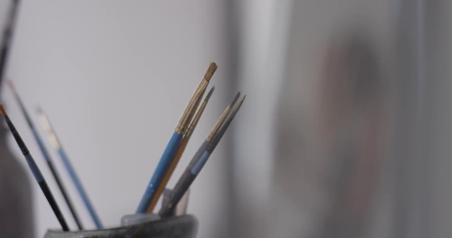 Cup with paintbrushes in it