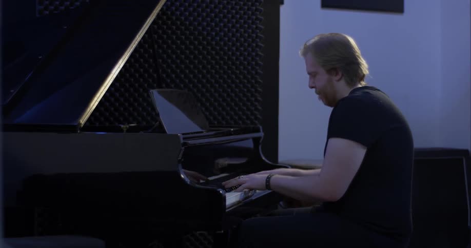 A man playing a grand piano
