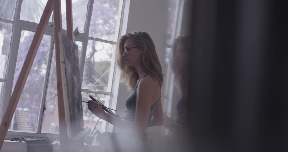 A woman painting in an art studio