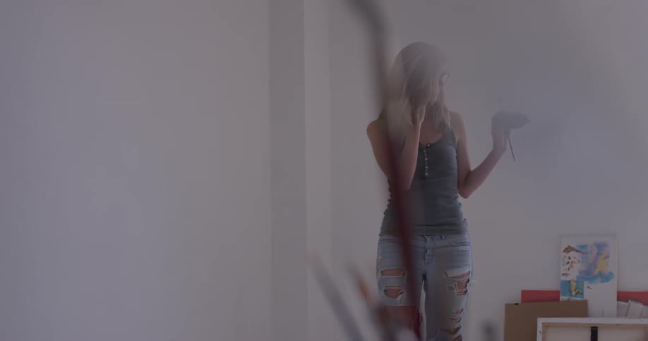 A woman talking on her phone in an art studio