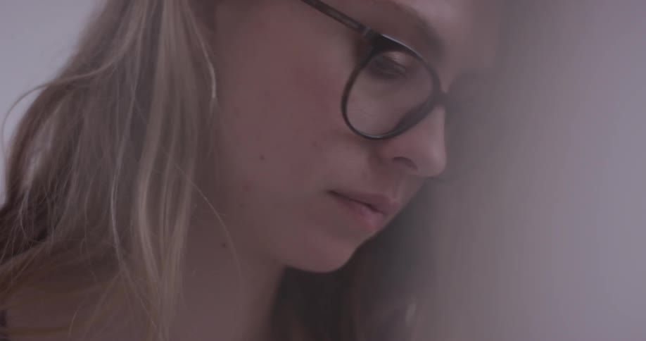 Woman looks down and over