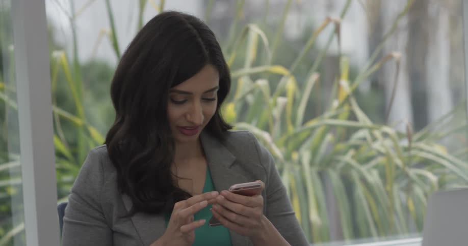 A woman typing on a phone