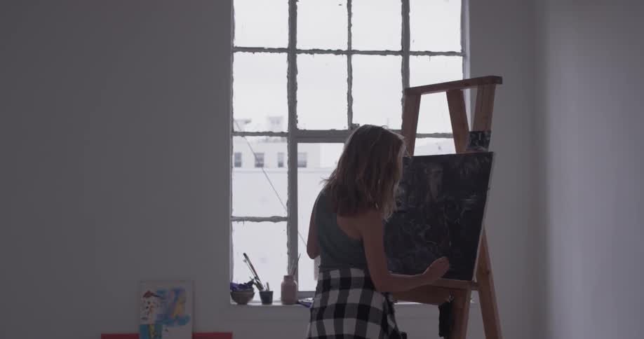 A woman painting in an art studio