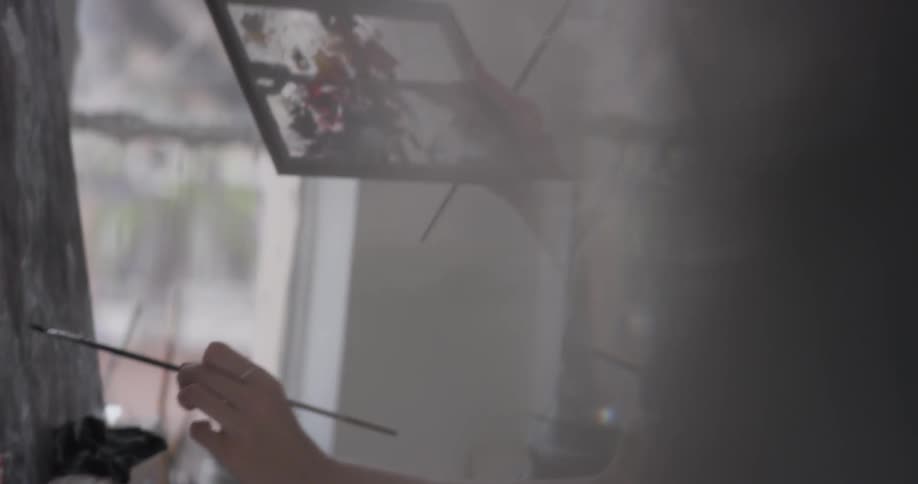 Woman painting on a canvas in a studio