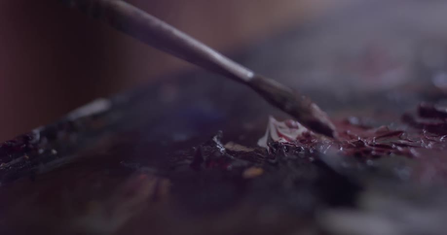 A person painting on a canvas
