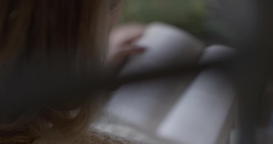 A woman reading a book outdoors