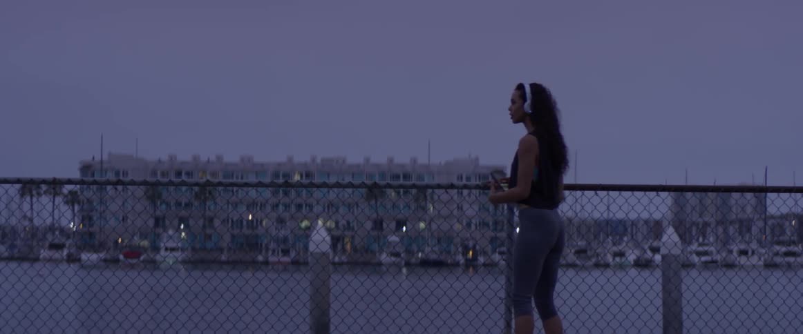 A woman jogging with a phone in her hands