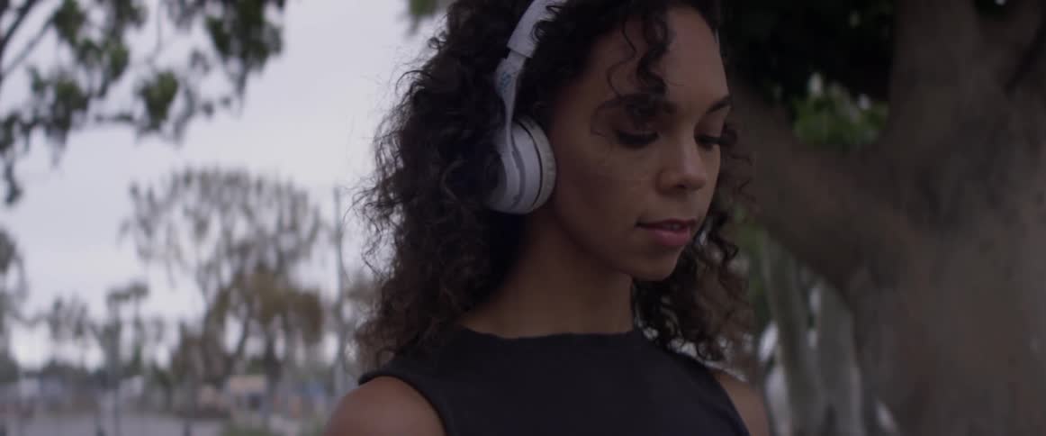 A woman listening to music outdoors