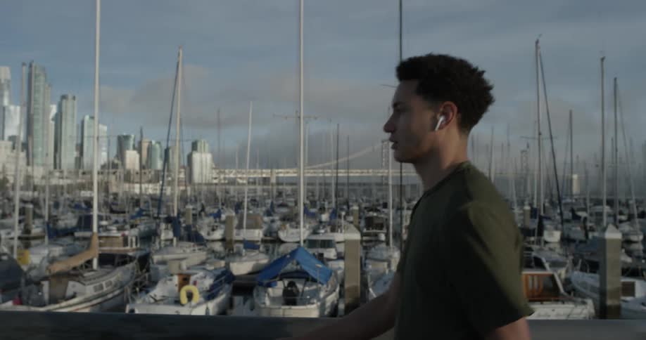A man walking around near a marina