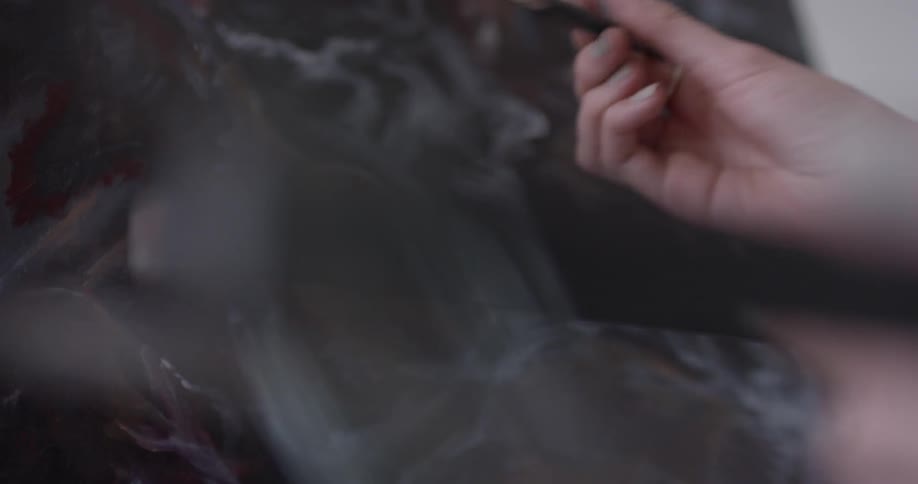 A woman painting on a canvas