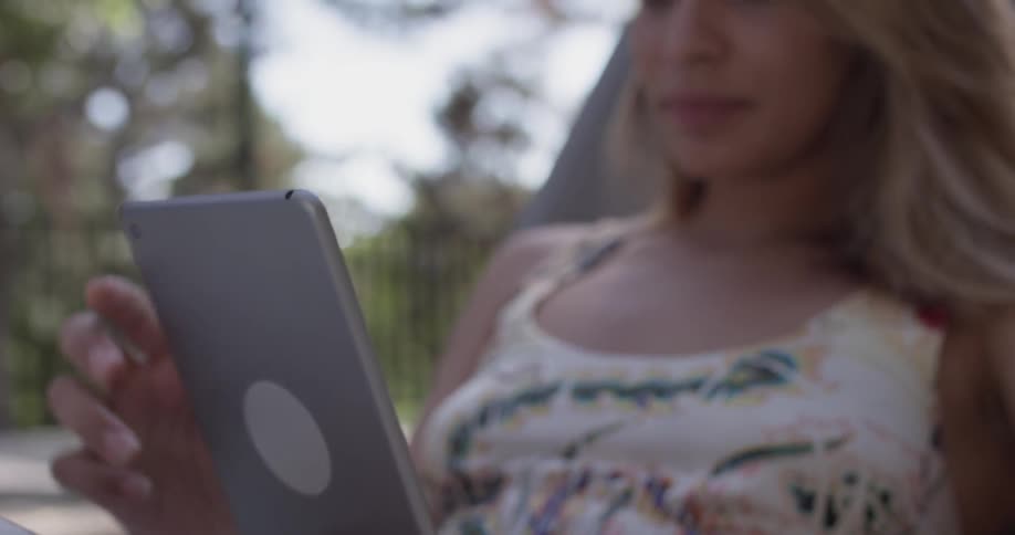 A woman is looking at a phone while sitting down