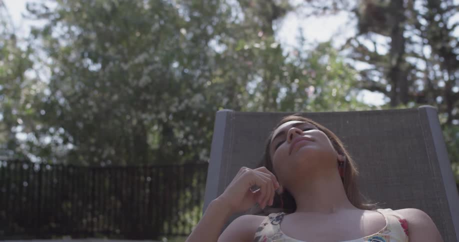 Woman Relaxing By The Pool