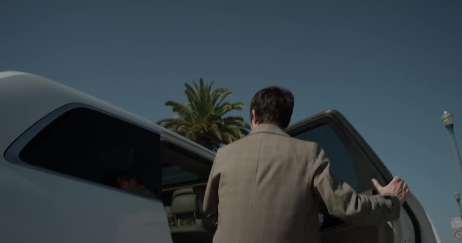 Man gets into backseat of white suv