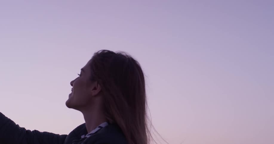 Woman taking a selfie at sunset