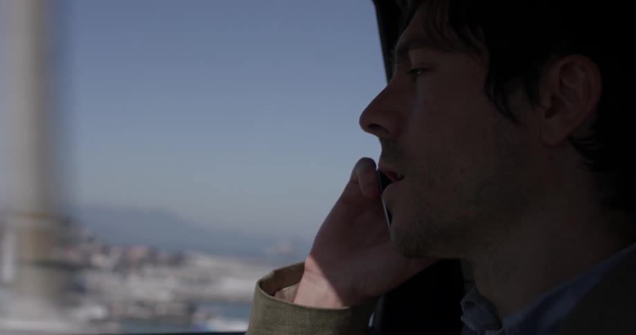 Man answering a phone call in a car