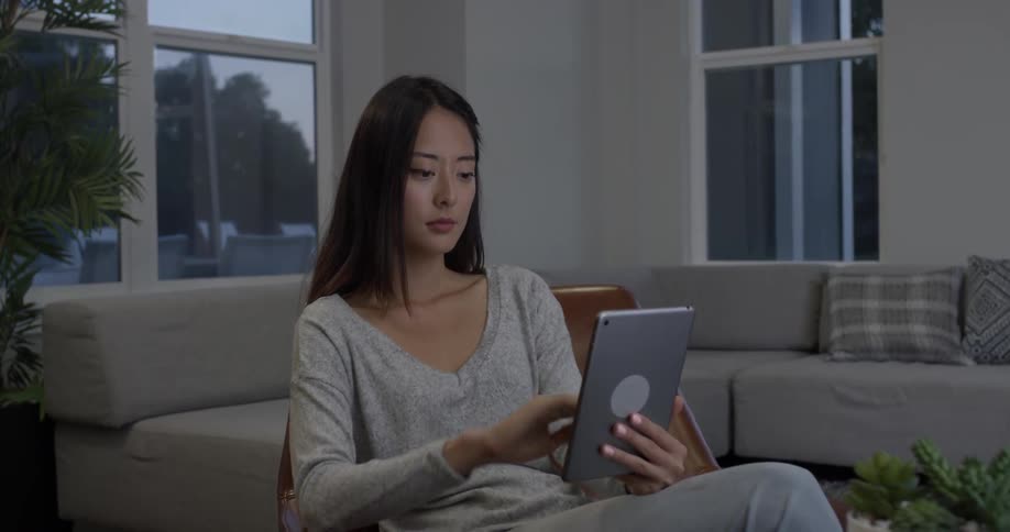 Woman using a tablet in a living room