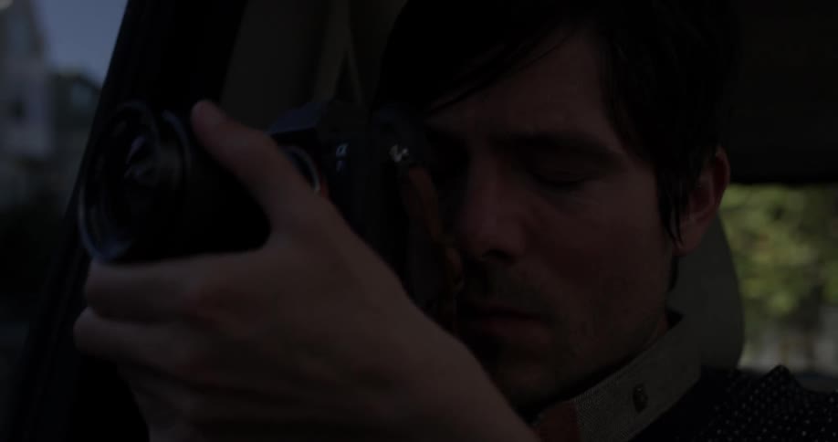 Man takes a picture while riding in a vehicle