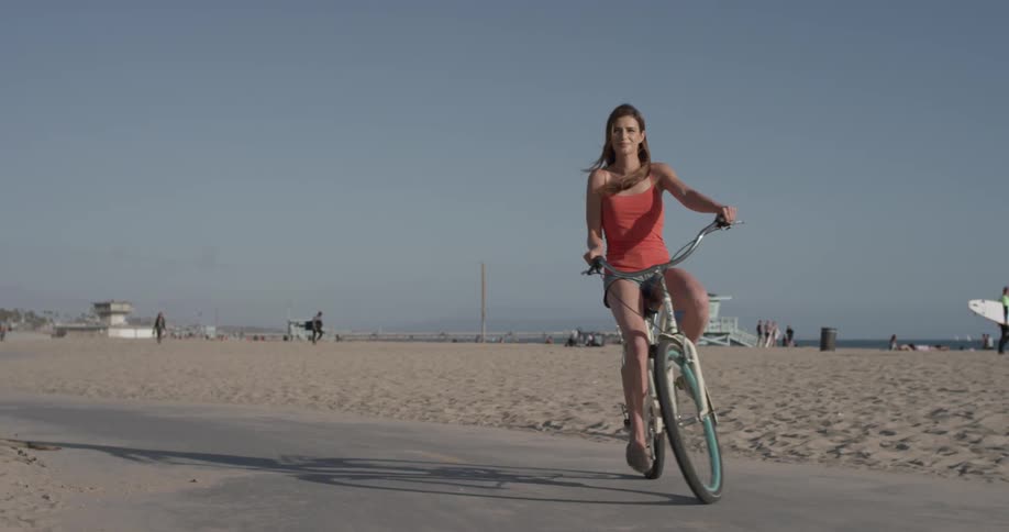 Woman riding a bicycle down by the beach